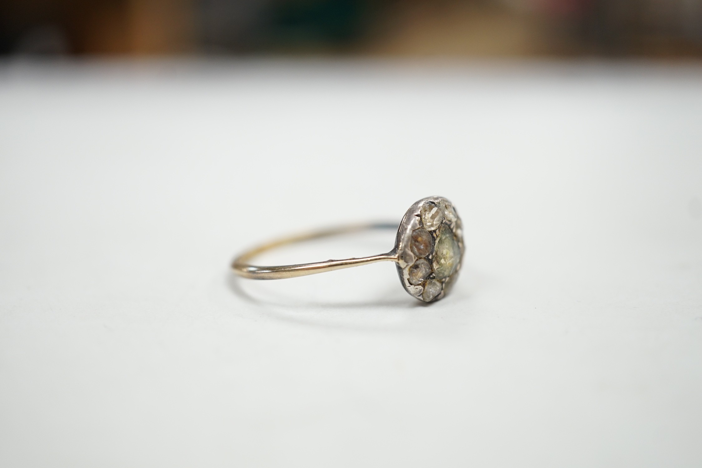 An antique yellow and white metal set rose cut diamond cluster ring, size S/T, gross weight 2.2 grams.